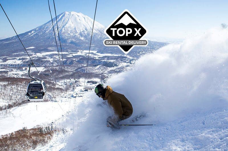 A skier in deep powder below Mount Yotei